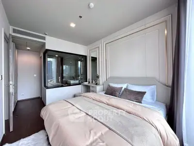 Luxurious modern bedroom with elegant decor and large windows offering stunning city views.