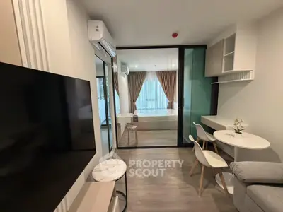 Modern studio apartment with open layout, featuring a cozy living area and stylish furnishings.