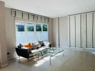 Spacious modern living room with large windows and stylish furniture