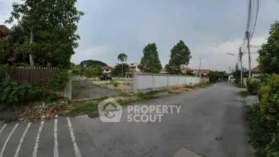 Spacious residential plot in a serene neighborhood with lush greenery and potential for development.