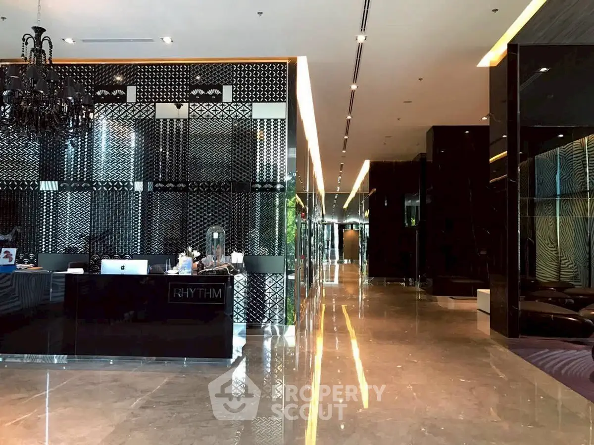 Luxurious modern building lobby with elegant decor and polished marble floors.