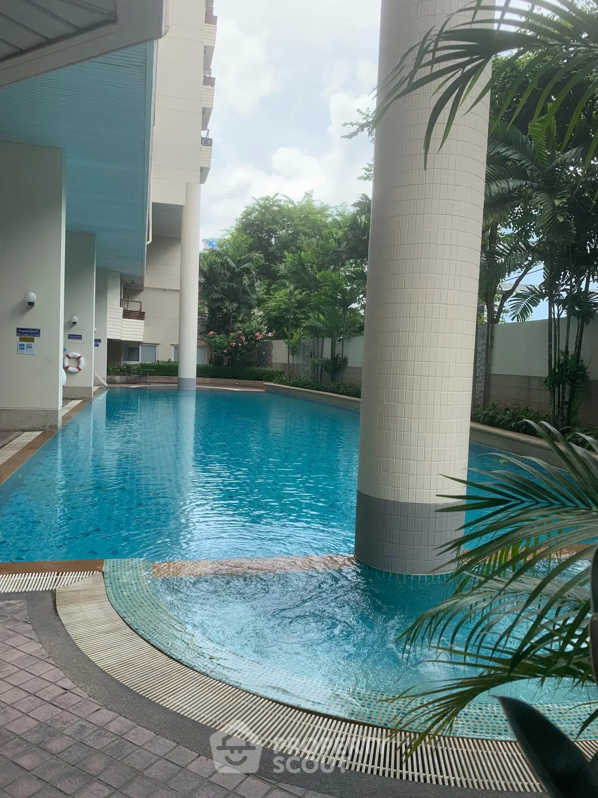 Luxurious residential pool with lush greenery and modern architecture