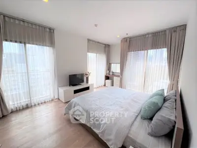 Spacious modern bedroom with large windows and stylish decor