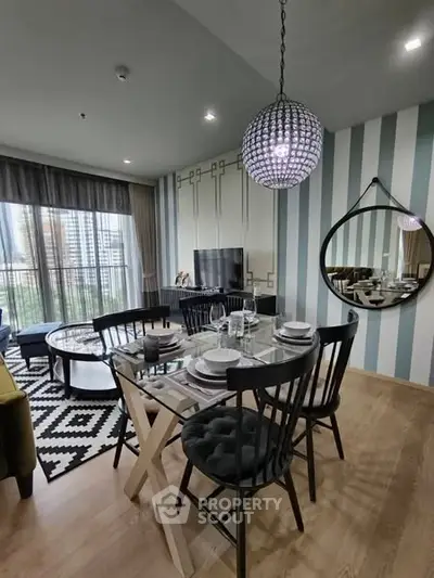 Stylish modern living room with dining area and chic decor in a high-rise apartment.