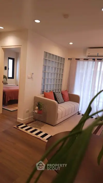 Chic modern living room with cozy sofa and stylish decor in a contemporary apartment.