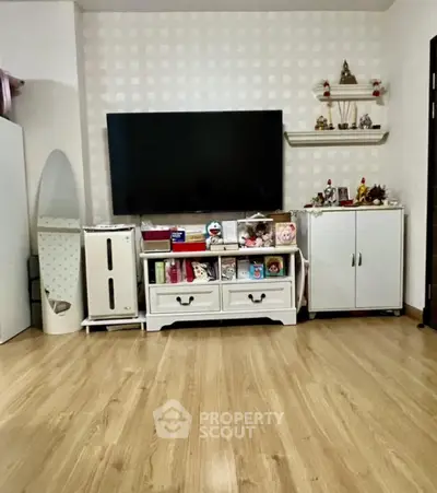 Cozy living room with modern TV setup and stylish wooden flooring