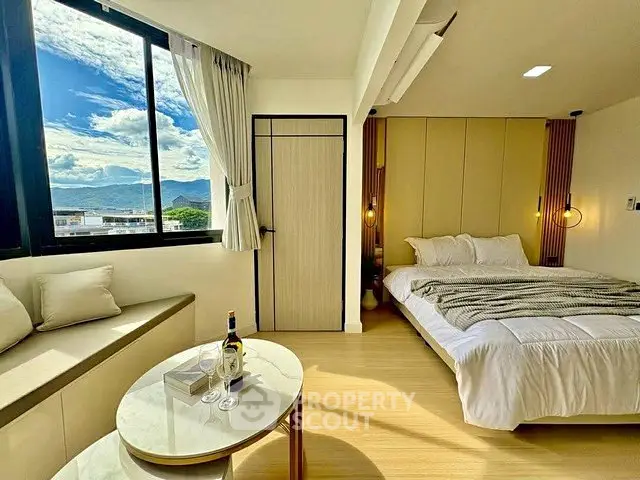 Luxurious bedroom with stunning mountain view, cozy seating area, and elegant decor for ultimate relaxation.