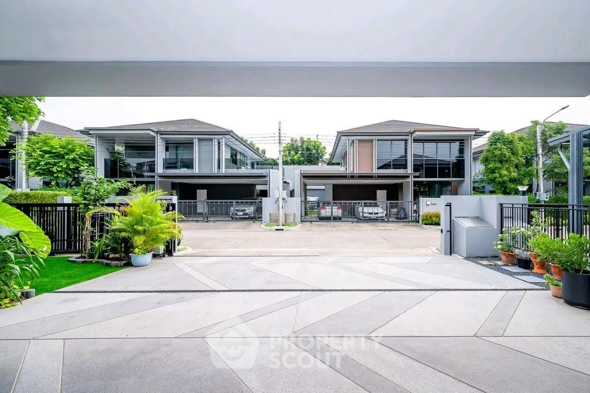 Modern residential complex with spacious driveways and lush greenery