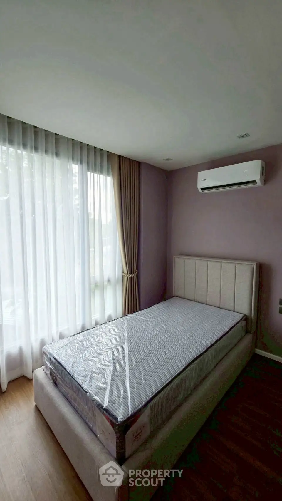 Cozy bedroom with natural light and air conditioning in modern apartment