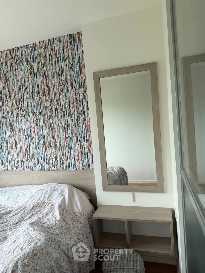 Chic bedroom with modern decor and colorful accent wall, perfect for stylish living.