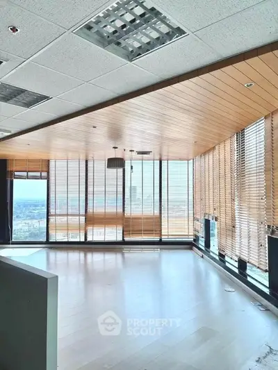 Spacious office with floor-to-ceiling windows and city view
