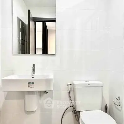 Modern bathroom with sleek white fixtures and contemporary design.