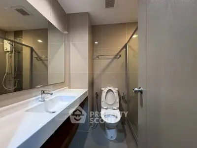 Modern bathroom with sleek fixtures and glass shower enclosure
