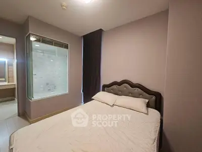 Cozy bedroom with modern design and adjacent bathroom view