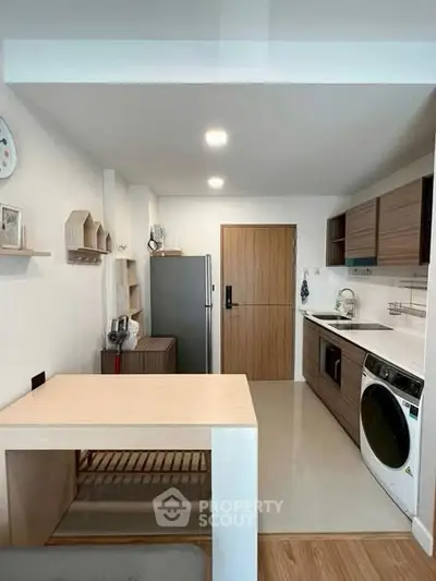 Modern kitchen with sleek appliances and stylish wooden cabinetry