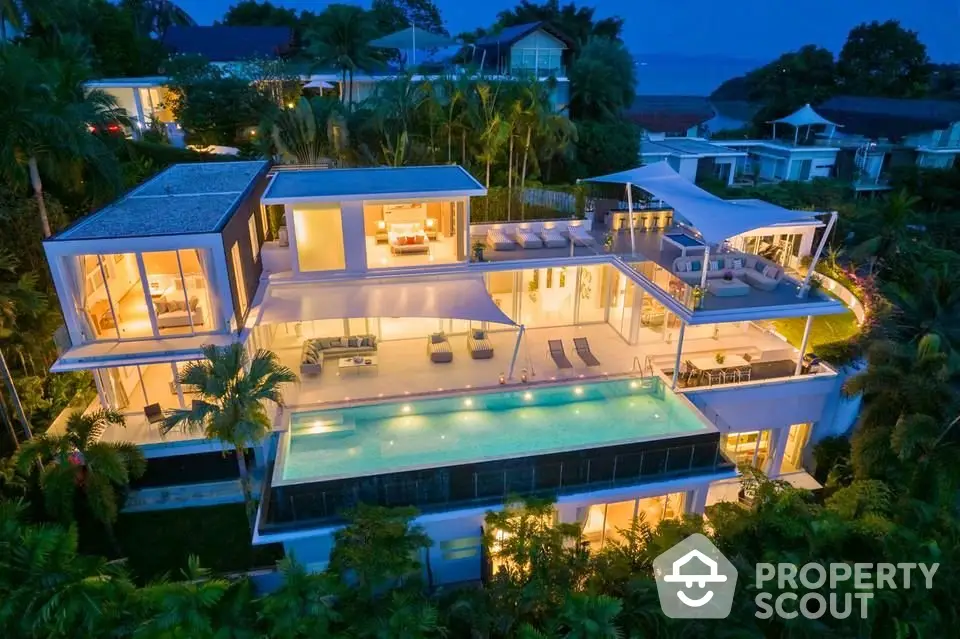 Luxurious multi-level villa with stunning pool and ocean view at dusk