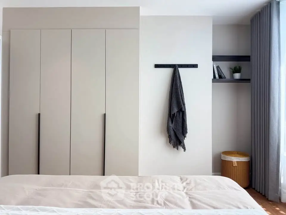 Modern bedroom with sleek wardrobe and cozy decor