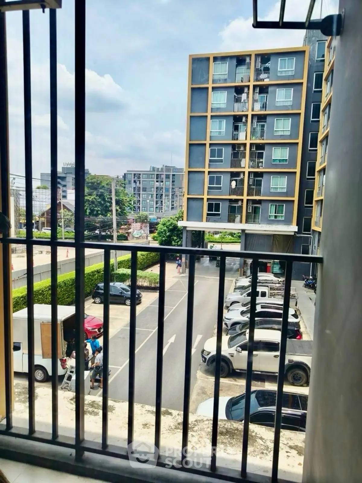 Modern urban apartment view with parking and cityscape