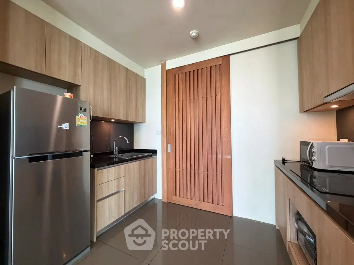 Modern kitchen with sleek wooden cabinets and stainless steel appliances