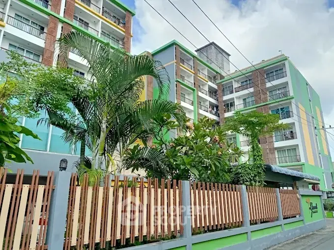 Modern multi-story residential building with lush greenery and vibrant facade.