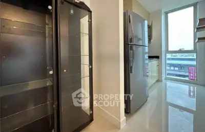 Modern kitchen with sleek appliances and glossy floors in a stylish apartment.