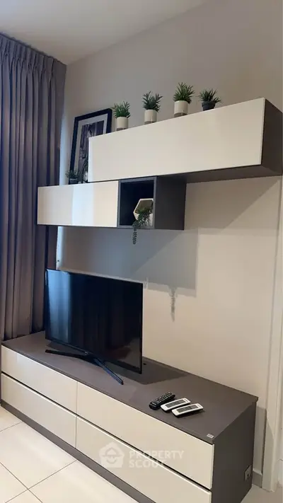 Modern living room with sleek TV unit and decorative plants