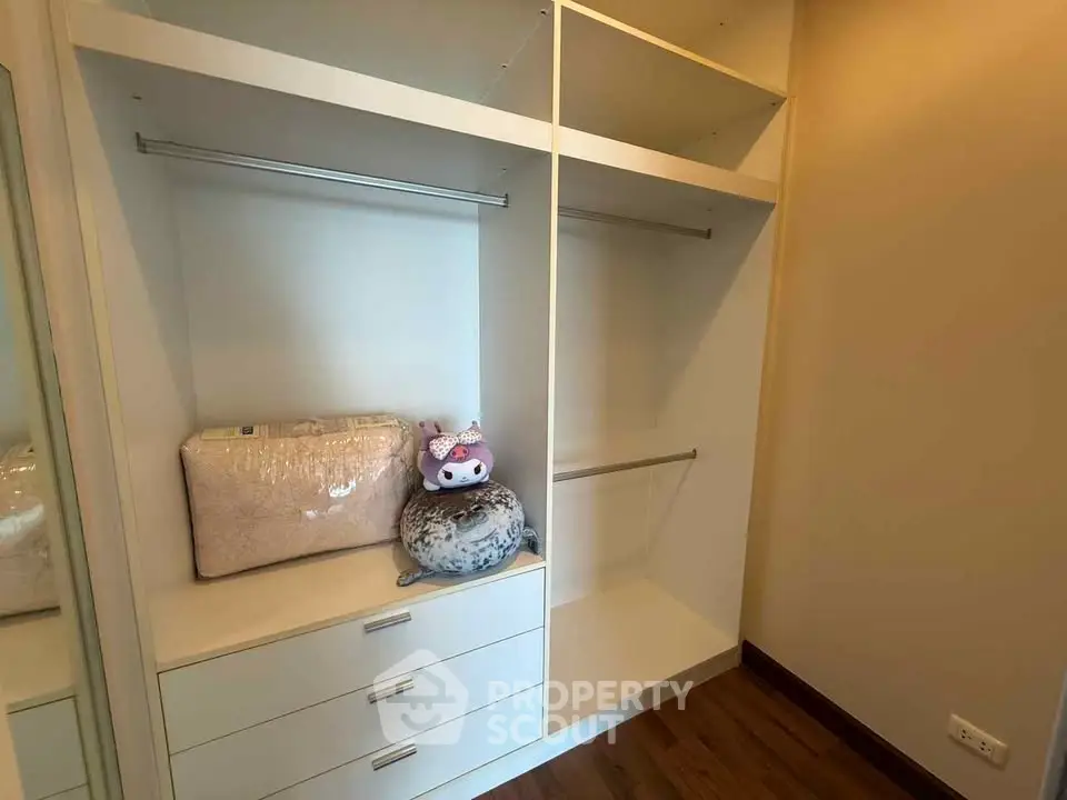 Spacious walk-in closet with built-in drawers and hanging space