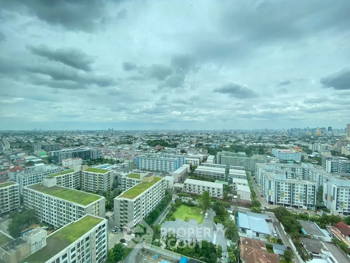 Stunning panoramic cityscape view from high-rise building showcasing urban skyline.