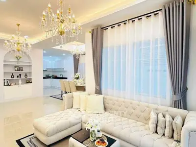Luxurious living room with elegant chandeliers and plush sectional sofa