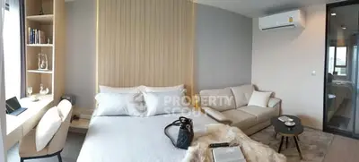 Modern bedroom with cozy seating area and stylish decor