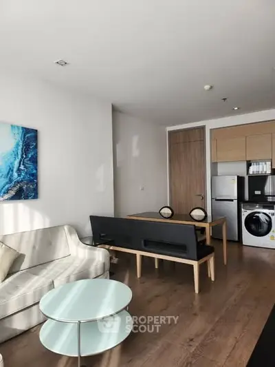 Modern living room with stylish furniture and integrated kitchen appliances