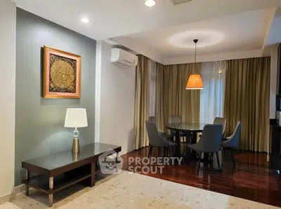 Elegant dining area with modern furniture and ambient lighting in a stylish apartment.