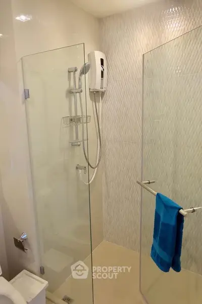 Modern bathroom with glass shower enclosure and sleek fixtures