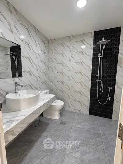Modern bathroom with sleek marble tiles and contemporary fixtures