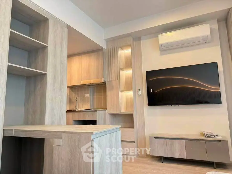 Modern living room with sleek wooden furniture and wall-mounted TV in a stylish apartment.