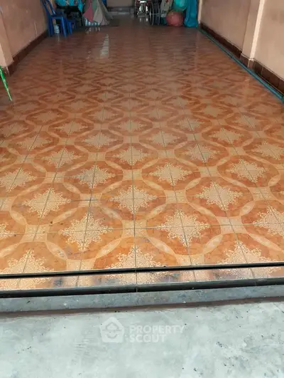 Spacious tiled area with decorative pattern, ideal for versatile use in residential or commercial property.