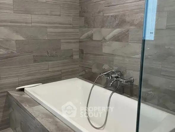 Modern bathroom with elegant bathtub and stylish tile design