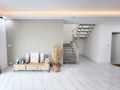 Modern minimalist living room with stylish staircase and elegant decor