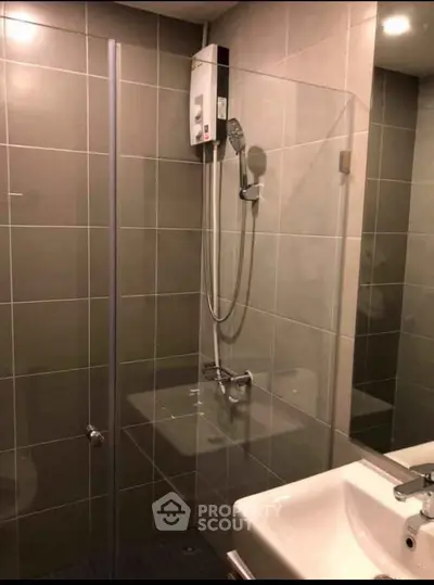 Modern bathroom with sleek tiles and glass shower enclosure
