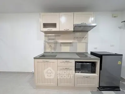 Modern compact kitchen with sleek cabinetry and appliances