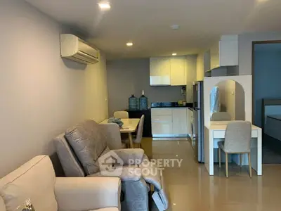 Modern living room with open kitchen layout and cozy seating area