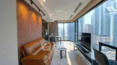 Luxurious modern living room with panoramic city views and elegant furnishings in high-rise apartment.