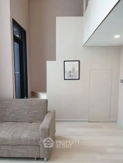 Modern living room with high ceiling and stylish decor in a contemporary apartment.