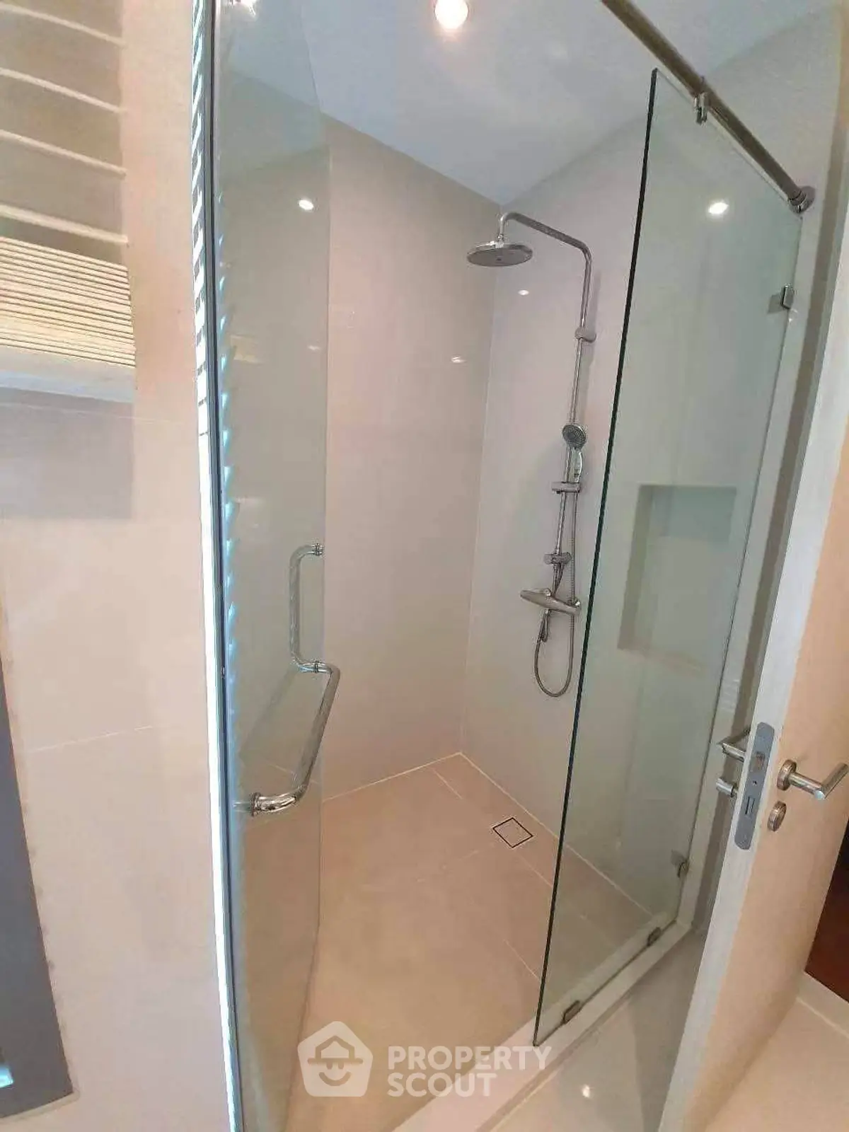 Modern bathroom with glass shower enclosure and sleek fixtures