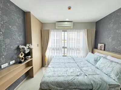 Modern bedroom with stylish decor and natural light, featuring a cozy bed and elegant furnishings.