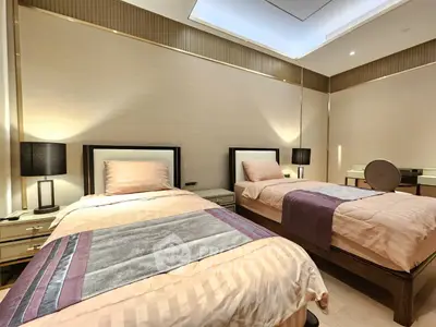 Luxurious twin bedroom with elegant decor and ambient lighting