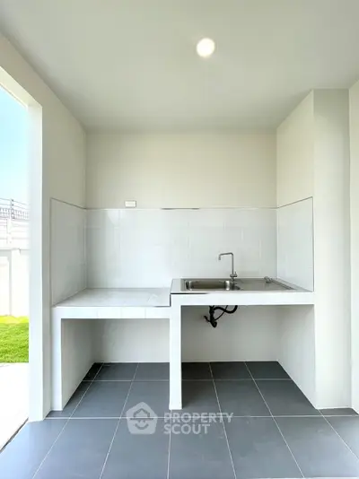 Modern minimalist kitchen with open layout and sleek tile design