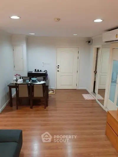 Cozy living room with wooden flooring and modern furniture in a stylish apartment.