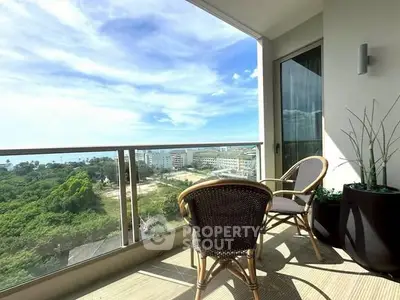 Stunning balcony with chairs offering breathtaking ocean and city views.