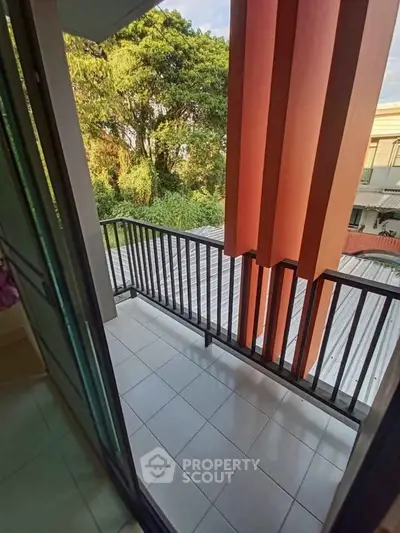 Charming balcony with lush greenery view, perfect for relaxation and outdoor enjoyment.